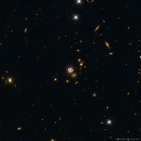  Four Quasar Images Surround a Galaxy Lens 