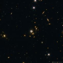  Four Quasar Images Surround a Galaxy Lens 